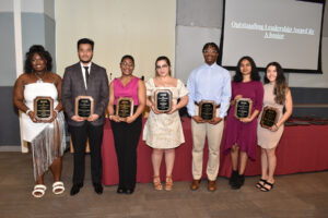 This picture features students holding awards at the reception. 