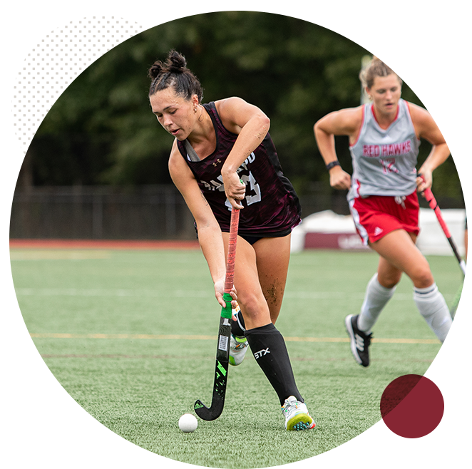 RCNJ Womens field hockey player hitting the ball with her stick