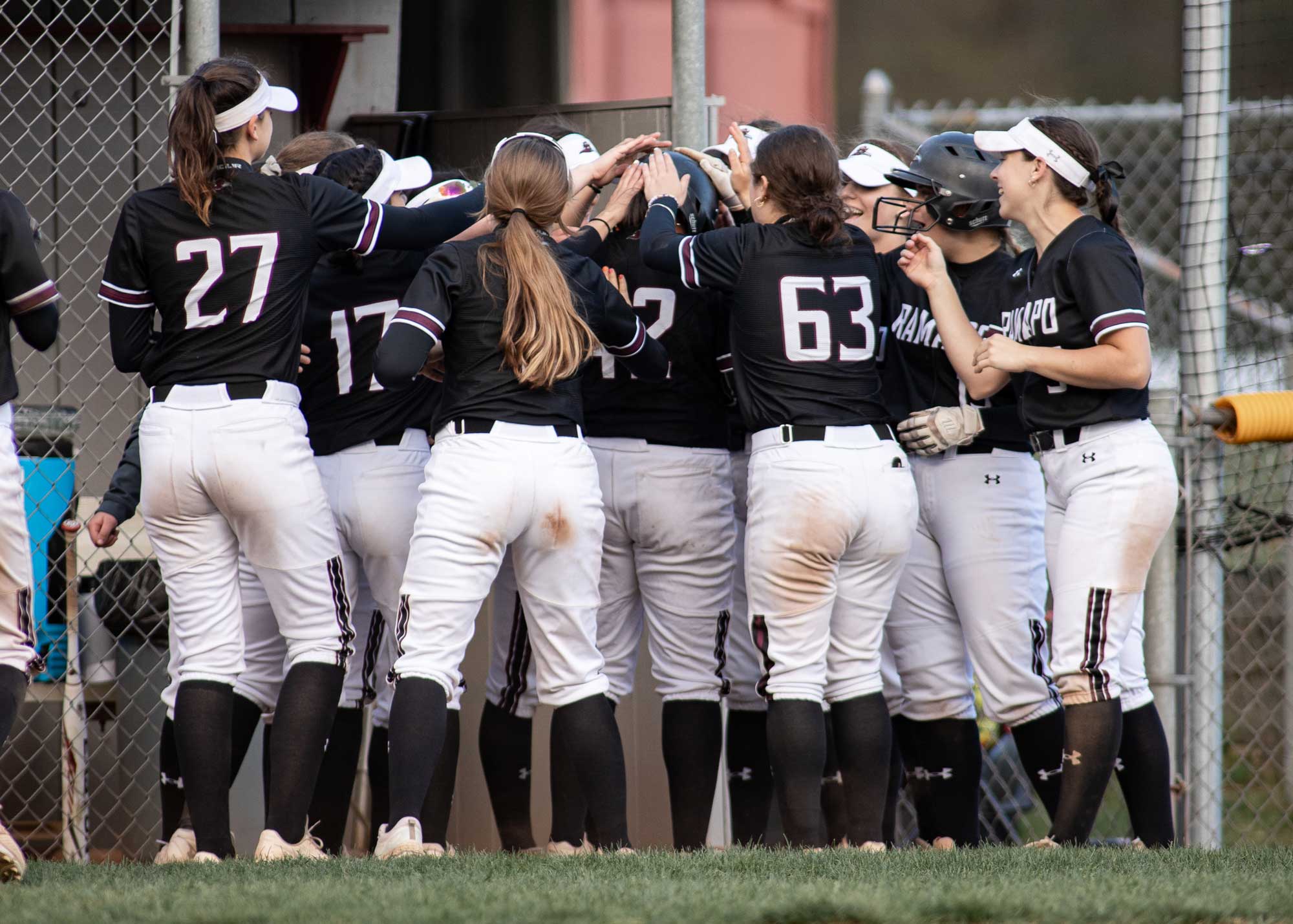 RCNJ Softball players in a group huddle
