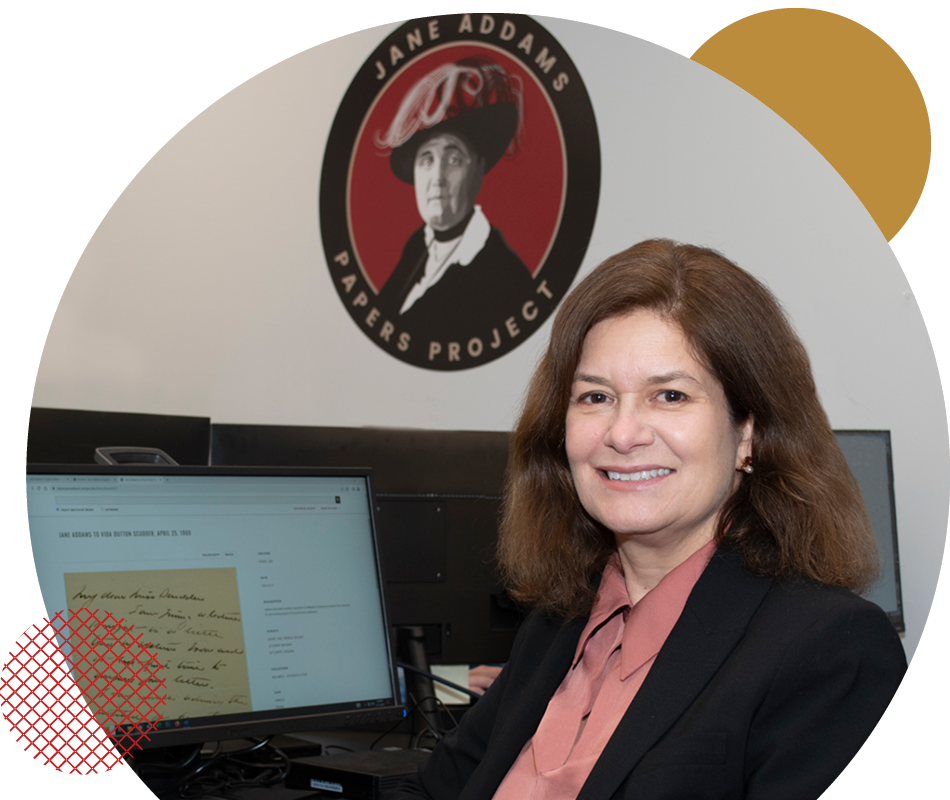 Susan Hangen, Ramapo’s dean of the School of Humanities and Global Studies sitting at a desk