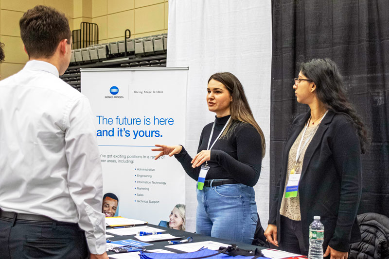 Future employers talking to students at Ramapo College's Career Fair event.