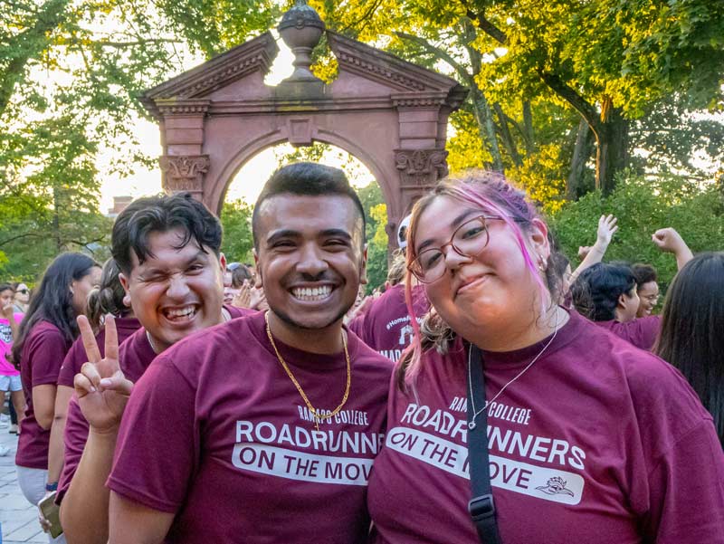 Students excitedly posting during Ramapo College's arching ceremony