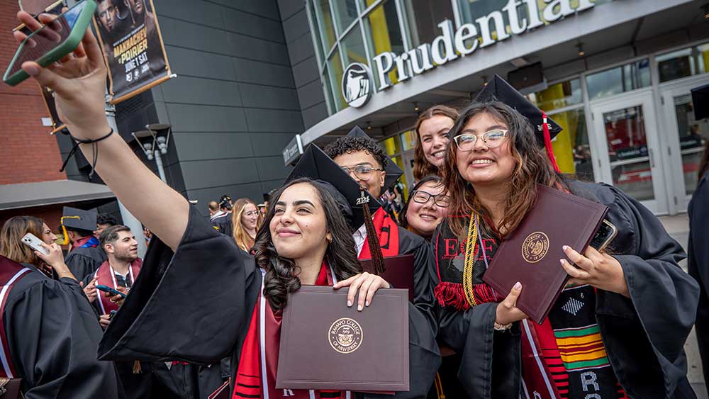 Ramapo College graduating students taking a selfie outside of the Prudential Center