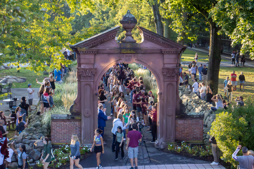 Students process under the Arch with family and friends cheering on either side of Mansion Road during the Arching ceremony