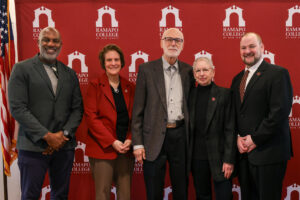 Group photo of Keith Dawkins, Cindy Jebb, Nick and Susan Vallario and Chris Romano in front of a maroon and white Ramapo College step and repeat.