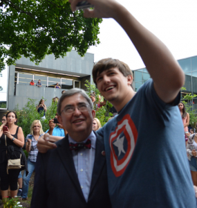 Incoming freshman takes a Selfie with President Mercer at the Arching Ceremony.