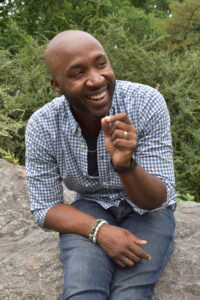 Smiling person sitting in nature